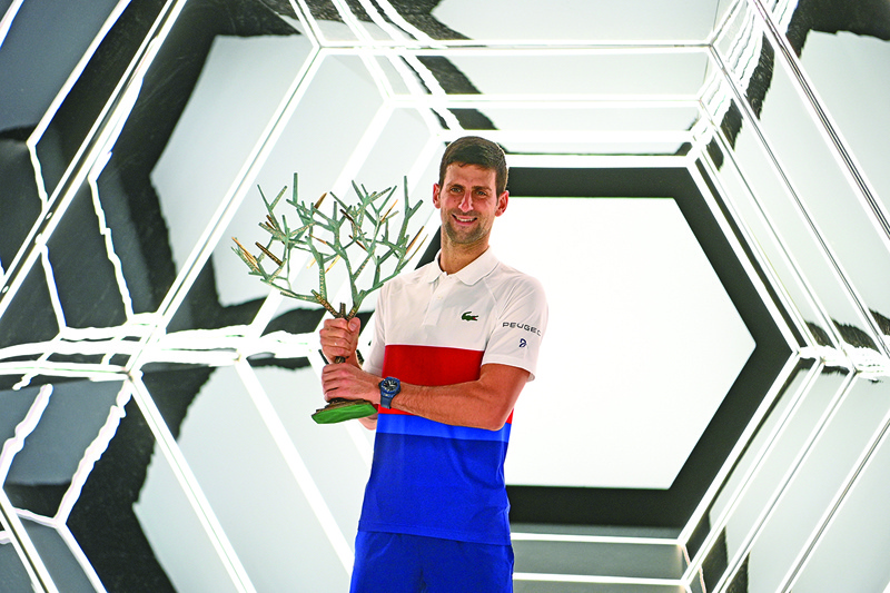 PARIS: Serbia's Novak Djokovic poses with the trophy after winning the ATP Paris Masters at The AccorHotels Arena in Paris on Sunday. – AFPn