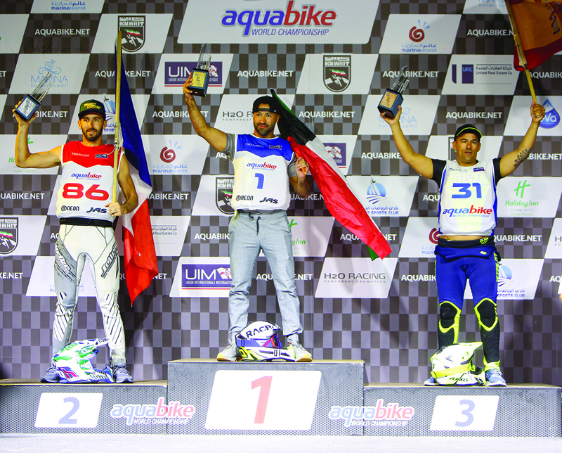 KUWAIT: Kuwait's Yousef Al-Abdulrazzaq (center), France's Jeremy Perez (left), and Spain's Alejandro Molina Miranda (right), winners of the runabout GP1 competition during the UIM ABP-Aquabike World Championship, pose with their trophies on the podium in Salmiya, Kuwait on Saturday. - Photos by Yasser Al-Zayyatn