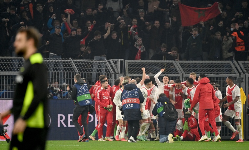 DORTMUND: Ajax celebrates victory with their fans after the team's UEFA Champions League Group C football match against Borussia Dortmund in Dortmund, western Germany on Wednesday. - AFPn