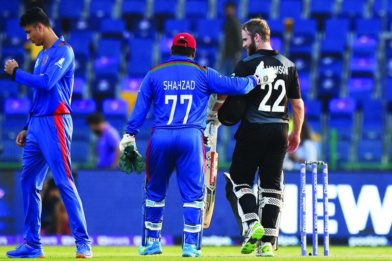 ABU DHABI: Afghanistan's Mohammad Shahzad (center) greets New Zealand's captain Kane Williamson at the end of the ICC men's Twenty20 World Cup cricket match between New Zealand and Afghanistan at the Sheikh Zayed Cricket Stadium in Abu Dhabi yesterday. - AFPn