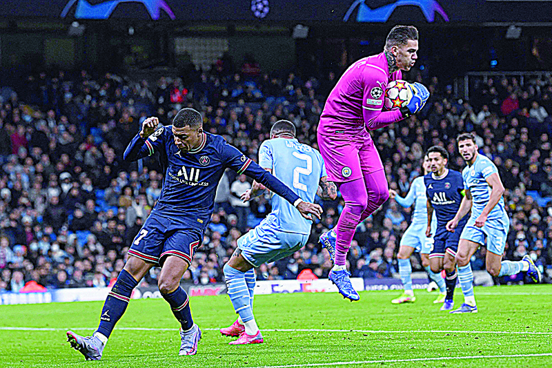MANCHESTER: Manchester City's Brazilian goalkeeper Ederson (centre right) catches the ball during the UEFA Champions League Group A football match between Manchester City and Paris Saint-Germain at the Etihad Stadium in Manchester, north west England. --- AFPn