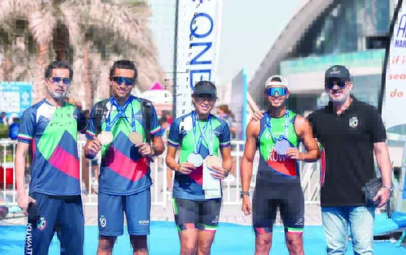 DOHA: Racers of Kuwait Triathlon Club pose with their medals. - KUNA