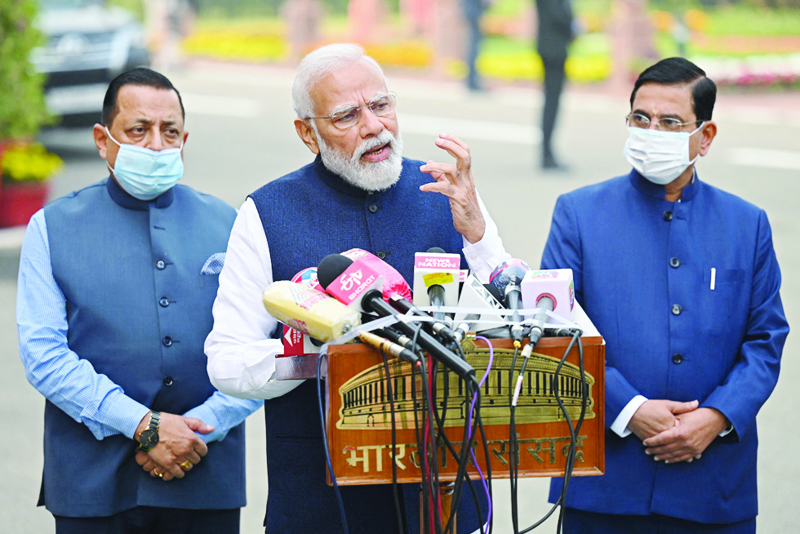 NEW DELHI: India's Prime Minister Narendra Modi (C) addresses the media upon his arrival to attend the winter session of the parliament in New Delhi yesterday. - AFPnn
