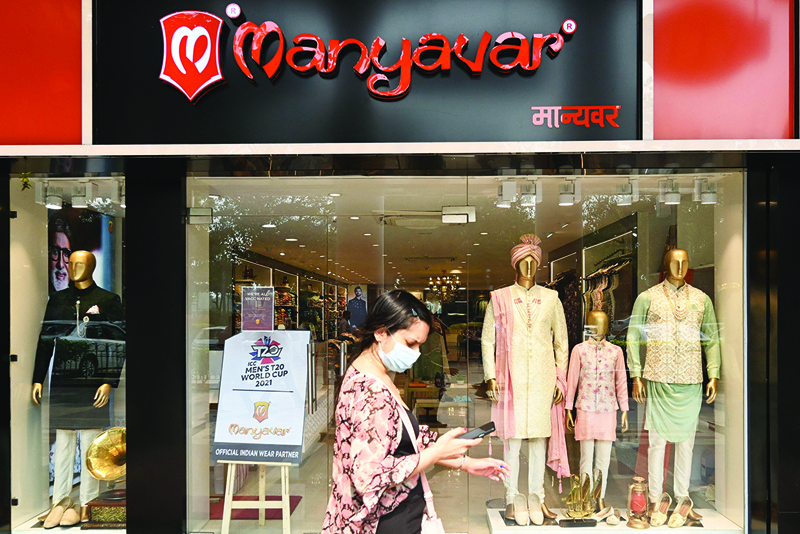 NEW DELHI: A pedestrian walks past Manyavar shoowroom at a market in New Delhi. India's biggest festive season is underway, but for the country's top brands the holiday's bring a surge in pressure from right-wing hardliners accusing them of hurting Hindu sentiments. - AFP n