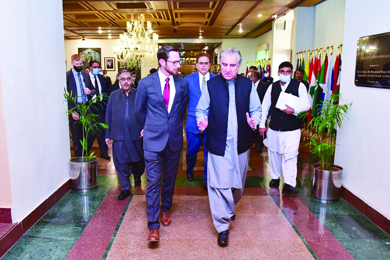 ISLAMABAD: Pakistan's Foreign Minister Shah Mahmood Qureshi (right) talking with US special representative to Afghanistan Thomas West (left) as they arrive to attend the 'Troika Plus' meeting on Afghanistan.-AFPnn