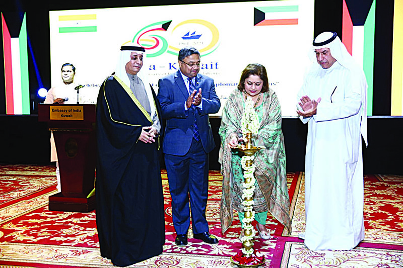 Joice Sibi lights the traditional lamp during the inauguration of the cultural festival as Dr Bader Al-Duwaish (left), Sibi George and Salman A Boland look on.n