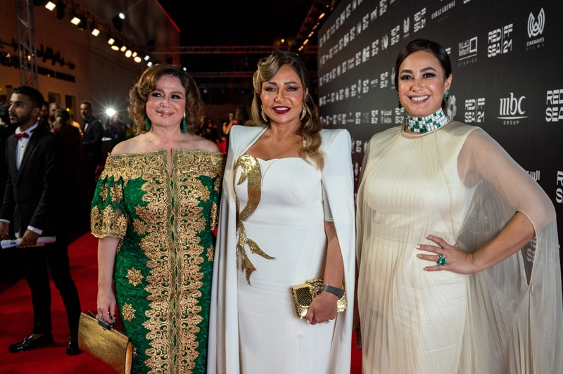 A handout picture released by the Red Sea Film Festival shows Egyptian actresses Elham Shahin and Laila Eloui and Tunisian actress Hend Sabry on the red carpet. - AFP photosn