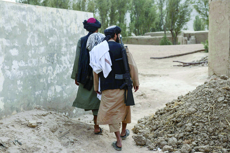 KANDAHAR, Aghanistan: This picture taken on November 7, 2021 shows Taleban members walking near the birthplace of Taleban Supreme Leader Hibatullah Akhundzada at the Sperwan village in Kandahar's Panjwai district. - AFPnnn