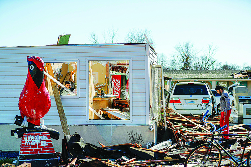 BOWLING GREEN, Kentucky: Pete Desai (L), owner of the Cardinal Motel in Bowling Green, Kentucky surveys tornado damage on December 12, 2021. Dozens of devastating tornadoes roared through five US states overnight, leaving more than 80 people dead. - AFPnnn