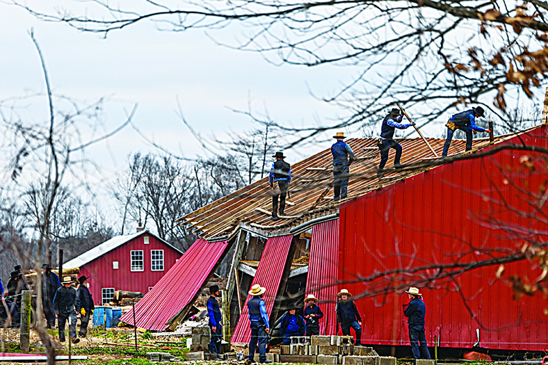 FULGHAM: Members of the Amish community repair a destroyed barn in Fulgham, Kentucky, on Wednesday five days after tornadoes hit the area. —AFP