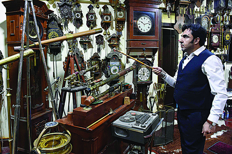 A collector Gul Kakar shows his antique clocks at a museum housed inside the city's tribal police headquarters compound in Quetta. - AFP photosn
