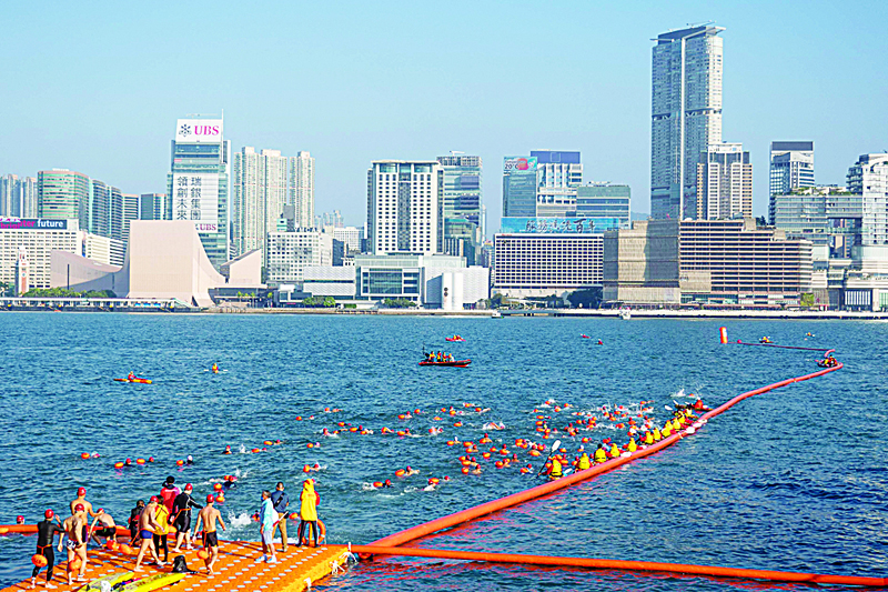 Swimmers compete during the annual harbour swimming race in Hong Kong. - AFP photos