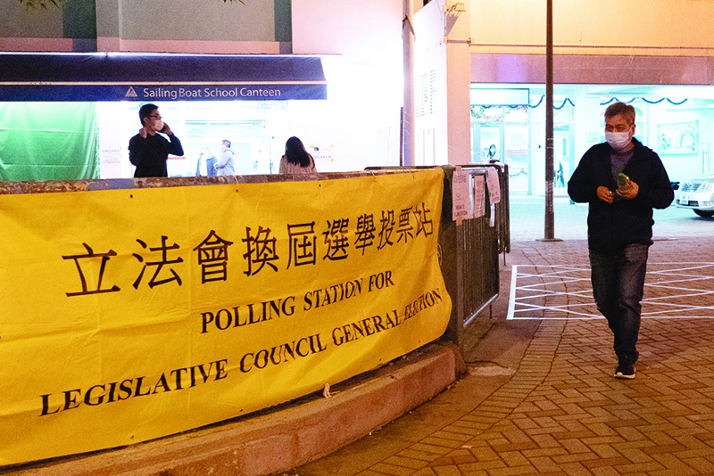 HONG KONG: A voter leaves a polling station during the Legislative Council election in Hong Kong’s Choi Hung area yesterday. —AFP