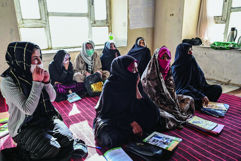 NAWABAD, Afghanistan: Picture taken on November 14, 2021 shows female students sitting inside a classroom of grade 12 at a school in Langar village, in the Qarabagh district, some 56 km south-west of Ghazni, in Ghazni province. - AFPnn