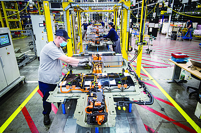 TRNAVA, Slovakia: This file photo taken on July 16, 2020 shows an employee assembling a battery-pack for electric cars at the assembly line at the PSA Peugeot Citroen plant in Trnava, Slovakia.—AFP