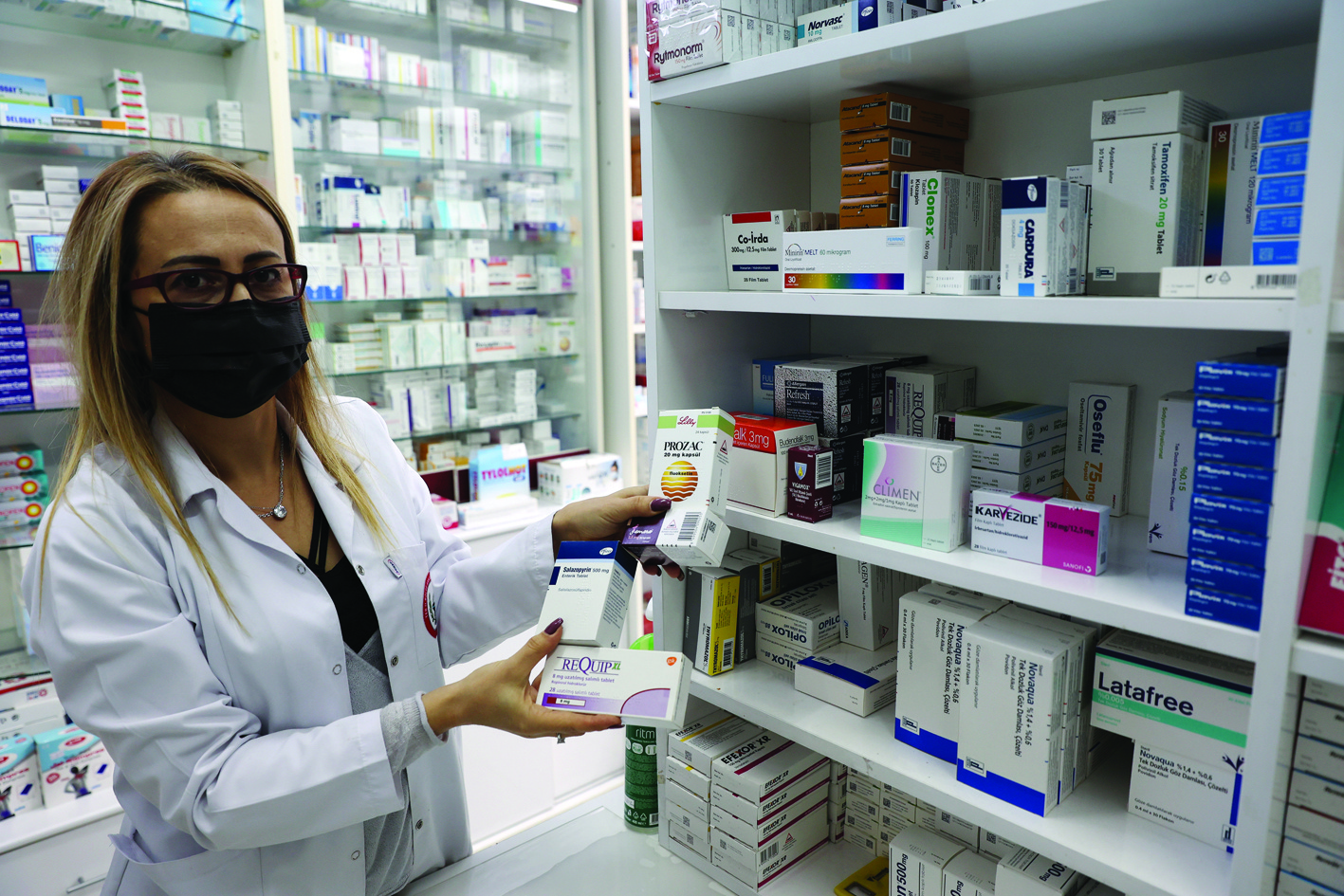 ANKARA: Turkish pharmacist Berna Yucel Mintas shows boxes of medicines at her pharmacy in Ankara yesterday. — AFP