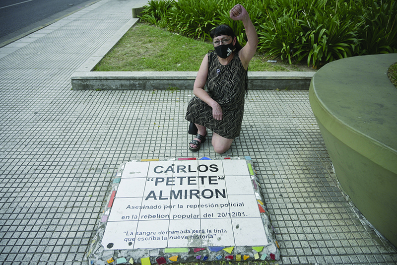 BUENOS AIRES, Argentina: Maria Laura Verdu, lawyer of the human rights group National Coordinator Against Police and Institutional Repression (CORREPI), poses during an interview next to a plaque remembering the place where protester Carlos Almiron was killed by policemen on December 20, 2001. —AFP