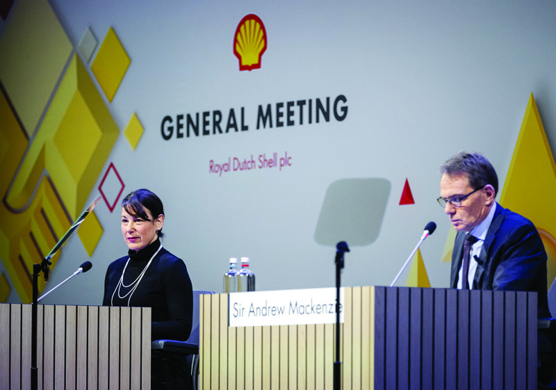 ROTTERDAM, Netherlands: CFO Jessica Uhl and Chairman of the Board Sir Andrew Mackenzie (right) attend the shareholders' meeting in Rotterdam, about the move of the oil giant to the United Kingdom, Friday.-AFPnn