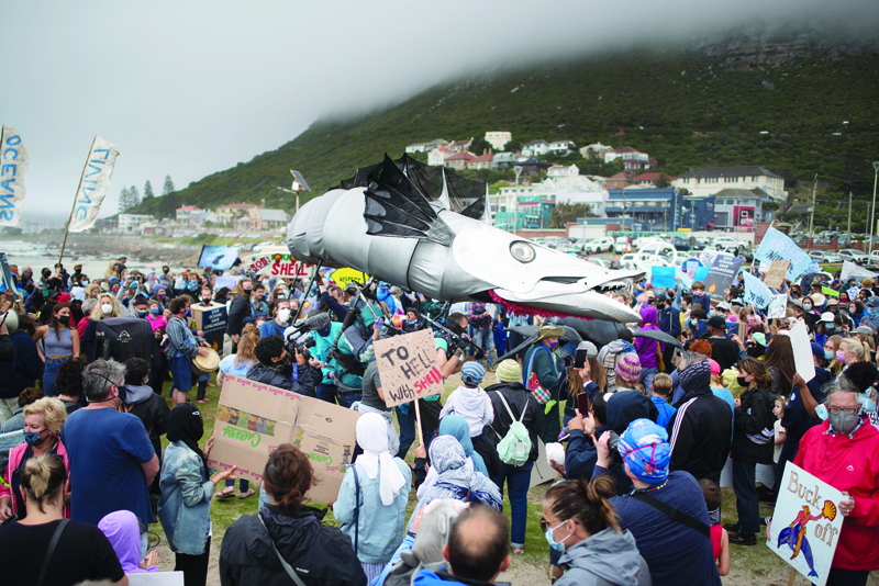 CAPE TOWN: A giant puppet of a Snoek, a type of common local Mackeral, is displayed as hundreds of people take part in a protest against the plan by Dutch oil company, Shell, to conduct underwater seismic surveys along South AfricaÕs East coast, at Muizenberg Beach, in Cape Town, yesterday.-AFPn