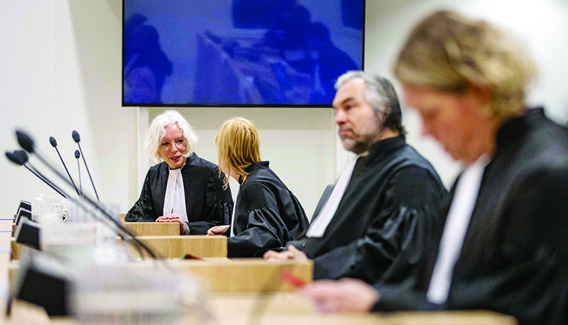 SCHIPHOL, Netherlands: Members of the legal aid team MH17 Maja Spetter (L) and Peter Langstraat (3L) sit prior the final day of the prosecution of the Public Prosecution Service in the extensive criminal proceedings regarding the downing of flight MH17 in Badhoevedorp. —AFP