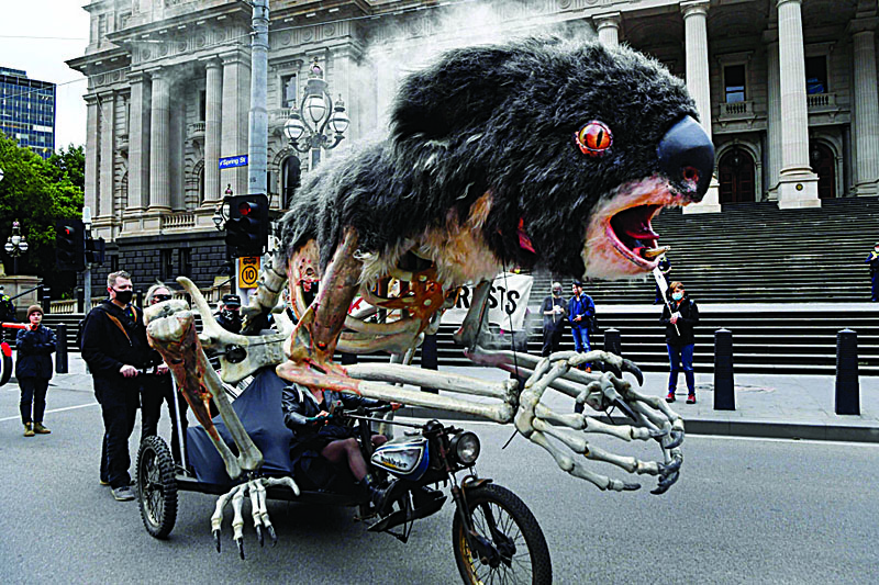 MELBOURNE: An art piece depicting a burning koala is displayed during a climate change protest in Melbourne yesterday. - AFP n