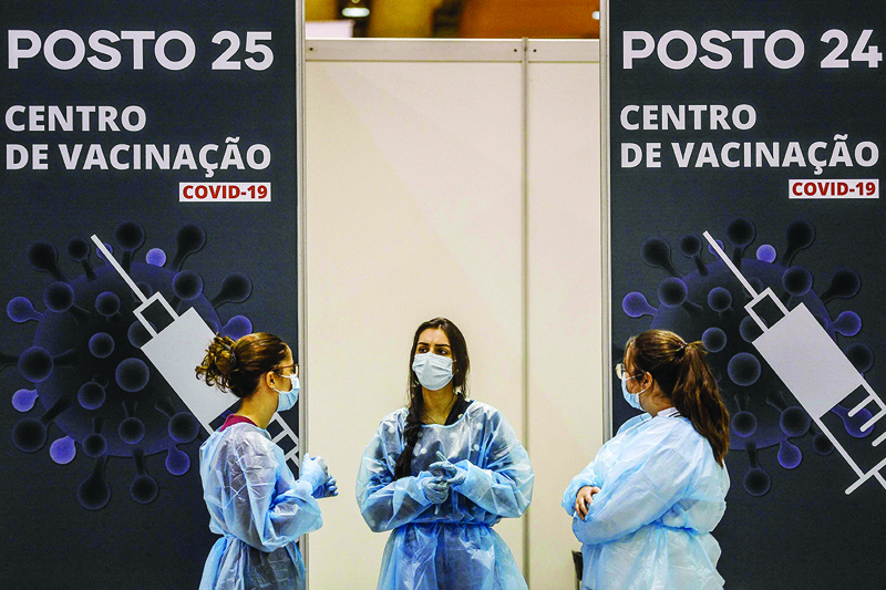 LISBON: Healthcare workers wait to administer a dose of COVID-19 vaccine to people, at the vaccination centre of Parque das Nacoes in Lisbon yesterday. - AFPnn