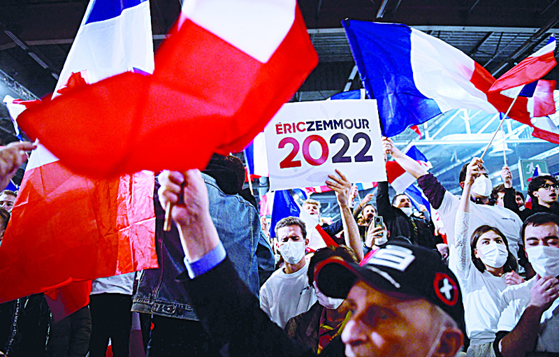 VILLEPINTE, Seine-Saint-Denis: Supporters of French far-right media pundit and 2022 presidential candidate Eric Zemmour wave French national flags and placards during a campaign rally in Villepinte, near Paris, yesterday. - AFPn