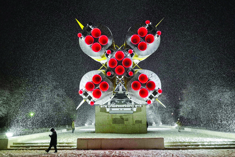 BAIKONUR, Kazakhstan: A woman walks under snowfall in front of a Soyuz rocket installed as a monument in Baikonur city. Space tourists Yusaku Maezawa and his assistant Yozo Hirano, led by Roscosmos cosmonaut Alexander Misurkin, will take part in a mission on the Soyuz MS-20 spacecraft to the International Space Station (ISS) scheduled for tomorrow. - AFPnn