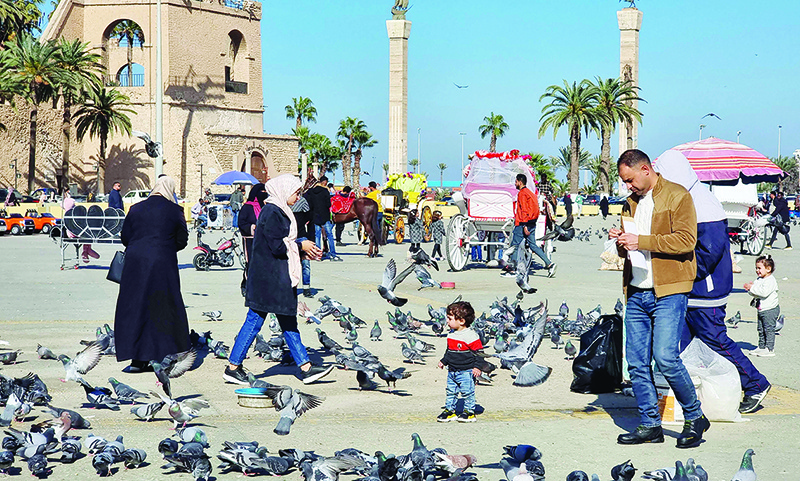 TRIPOLI: People visit the old town of the Libyan capital yesterday. — AFP