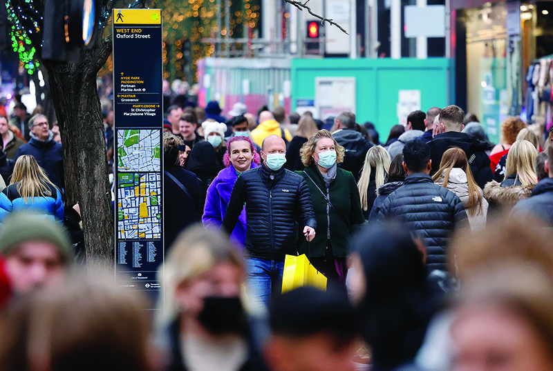 LONDON: Shoppers walk past stores on the final Saturday before Christmas on Oxford Street. — AFP