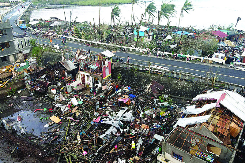 SURIGAO CITY, Philippines: This aerial photo taken on Friday shows destroyed houses caused by Super Typhoon Rai. — AFP