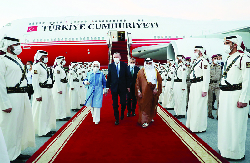 DOHA: Turkish President Recep Tayyip Erdogan and his wife Emine are welcomed by Qatari Finance Minister Ali bin Ahmed Al-Kuwari upon their arrival at Hamad International Airport yesterday. - AFP n