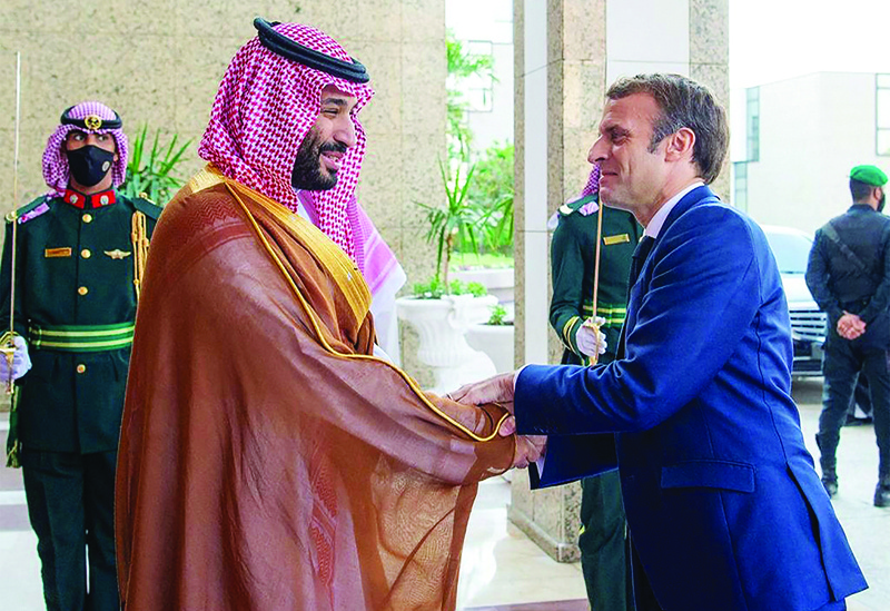 JEDDAH: Saudi Crown Prince Mohammed bin Salman (left) receives French President Emmanuel Macron in Saudi Arabia's Red Sea coastal city of Jeddah yesterday. - AFP n