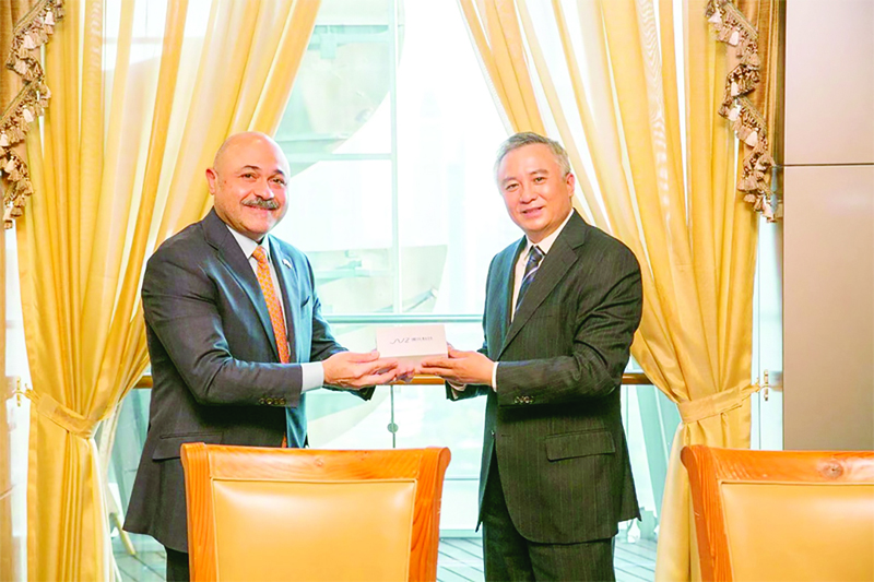 BEIJING: Kuwait's Consul General in Shanghai Mishal Al-Shamali (left) meets Shanghai International Port Group chief Gu Jinshan. - KUNAn