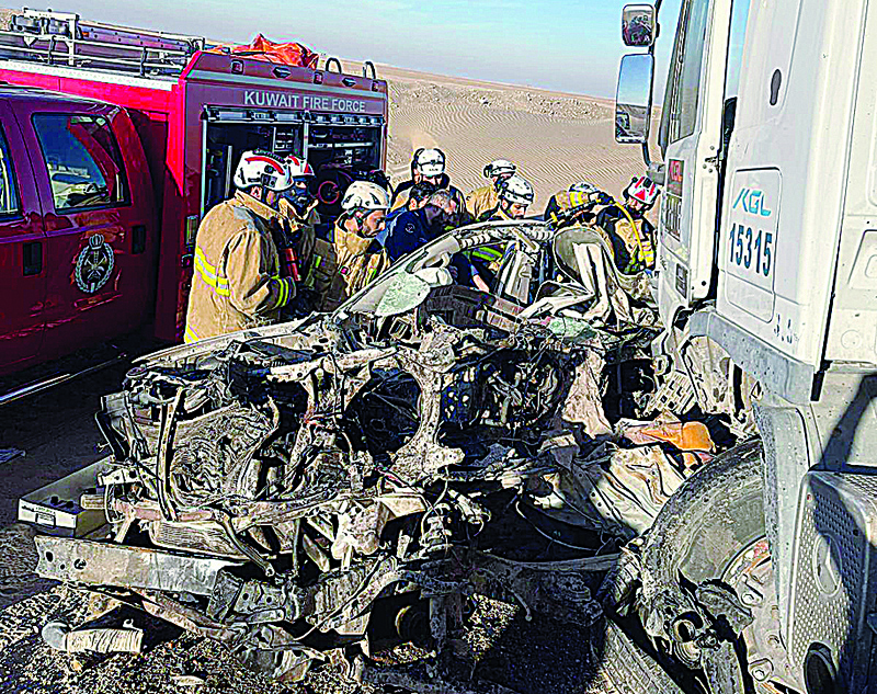 KUWAIT: Firemen are seen at the site of the fatal crash.n