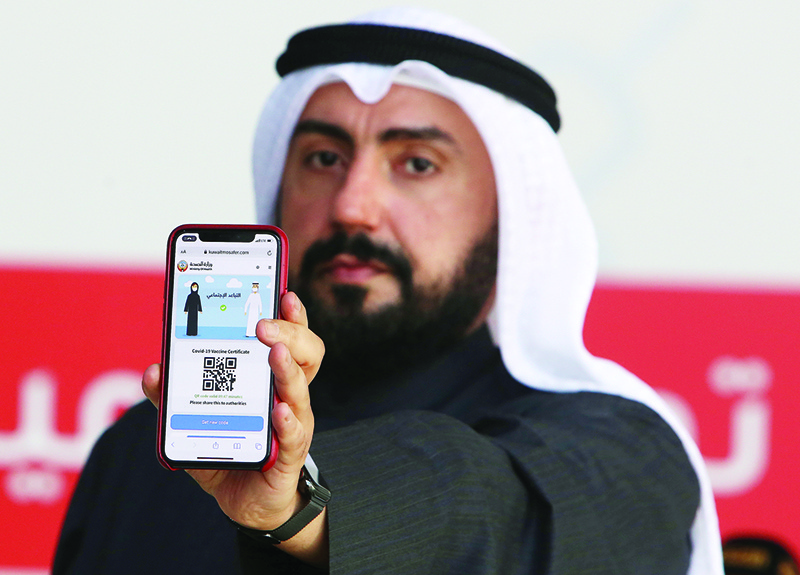 KUWAIT: Health Minister Sheikh Basel Al-Sabah shows the e-COVID-19 vaccine certificate on the Kuwait Mosafer platform at the Kuwait Vaccination Center in Mishref on January 14, 2021. —Photo by Yasser Al-Zayyat