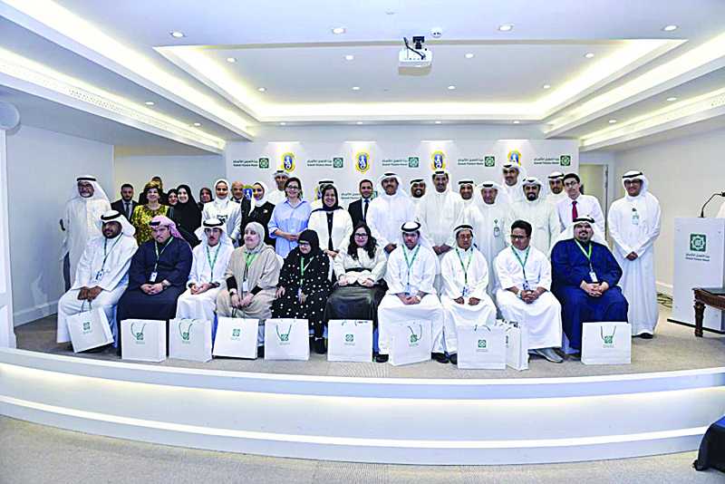 KUWAIT: Kuwait Finance House and Kuwait Society for the Handicapped in a group photo with the trainees.n