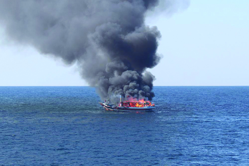 A handout photo released yesterday by the US Defense Visual Information Distribution Service (DVIDS) shows a fire burning after an explosion aboard a fishing vessel in the Gulf of Oman. —AFP