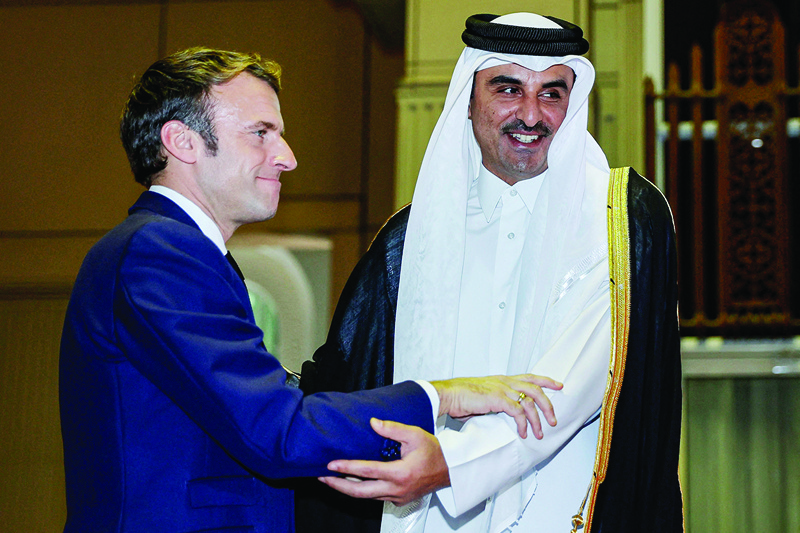 DOHA: Qatar's Amir Sheikh Tamim bin Hamad Al-Thani (R) receives French President Emmanuel Macron (L) at the Amiri Diwan in the capital Doha. - AFPnnn