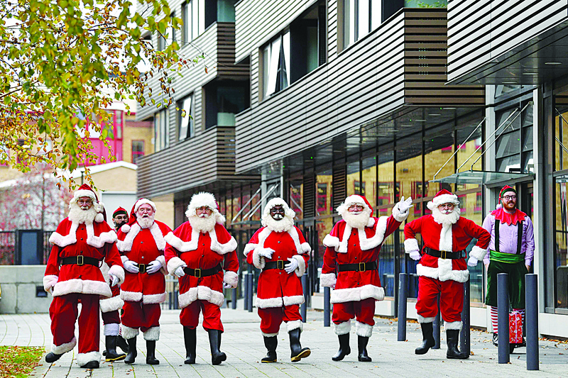 Santas arrive at The Ministry of Fun in London to take part in Santa School, a series of training courses for professional UK Santas.-AFP photosn