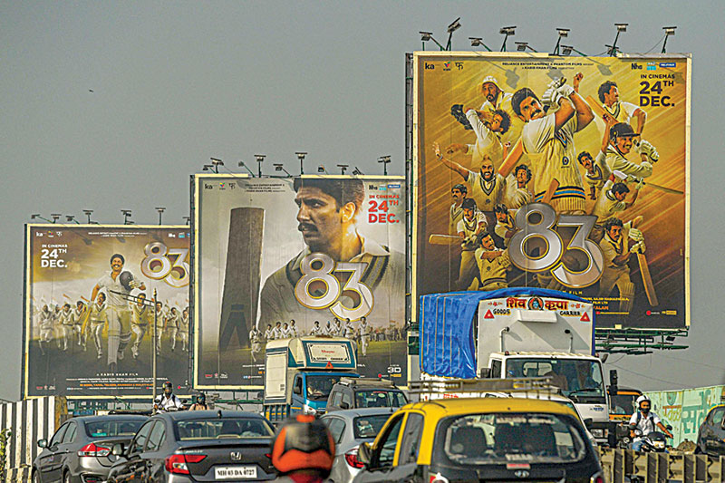 Vehicles move past billboards of Bollywood film ‘83’, which is based on India’s first cricket world cup victory in the year 1983, in Mumbai. —AFP
