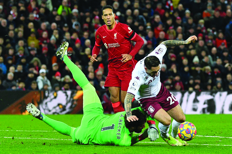 LIVERPOOL: Liverpool's Brazilian goalkeeper Alisson Becker (left) prevents a shot from Aston Villa's English striker Danny Ings during the English Premier League football match between Liverpool and Aston Villa at Anfield in Liverpool, north west England yesterday. - AFP n