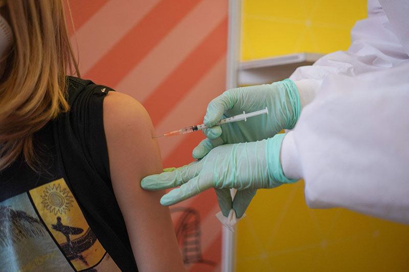 BERLIN: A 10-year-old girl is vaccinated against COVID-19 at a vaccination center for children at the museum of natural history yesterday. — AFP n