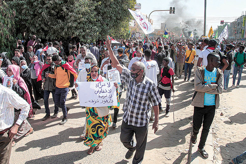 KHARTOUM: Protesters march during a mass demonstration demanding civilian rule in the Sahafa neighborhood in the south of the capital yesterday. —AFP