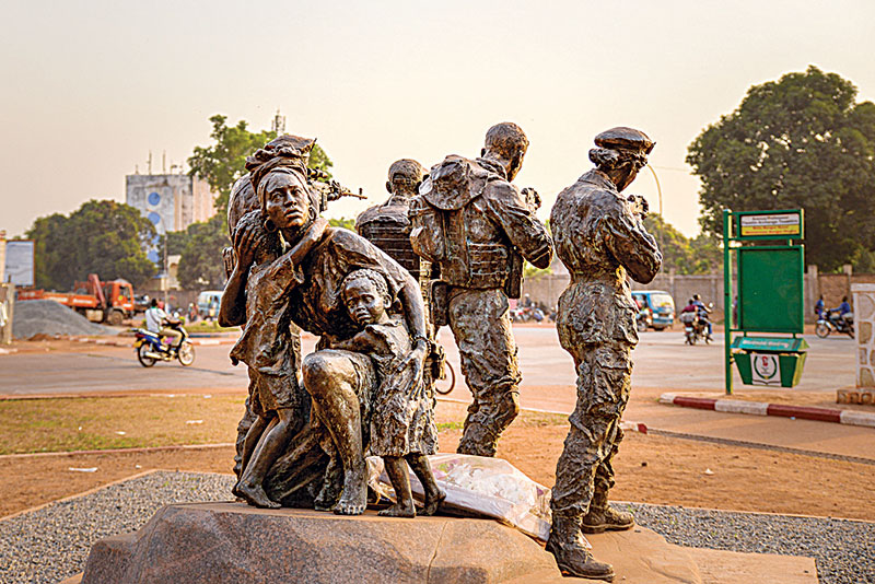 BANGUI: A monument depicting four armed men protecting a mother and her children is seen next to the University of Bangui on Nov 29, 2021. The monument pays tribute to the Russian private security armed forces and fighters who “died for the liberation” of the country, a symbol of a cumbersome influence. —AFP