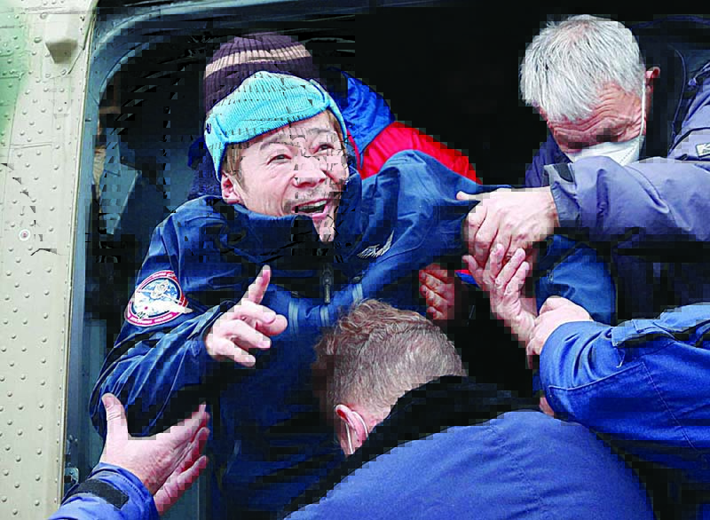 Japanese billionaire Yusaku Maezawa is helped to disembark from a helicopter as he arrives at Zhezkazgan airport after returning from the International Space Station (ISS) on the Soyuz MS-20 space capsule, in Zhezkazgan, Kazakhstan yesterday. —AFP
