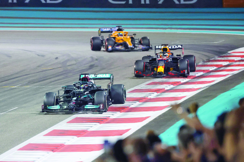 YAS ISLAND: Mercedes' British driver Lewis Hamilton 2021 (Front) is followed by Red Bull's Dutch driver Max Verstappen at the Yas Marina Circuit during the Abu Dhabi Formula One Grand Prix. - AFPn