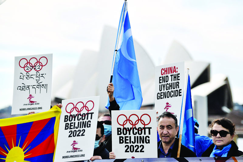 SYDNEY: Protesters hold up placards and banners as they attend a demonstration in Sydney to call on the Australian government to boycott the 2022 Beijing Winter Olympics over China's human rights record. - AFP n
