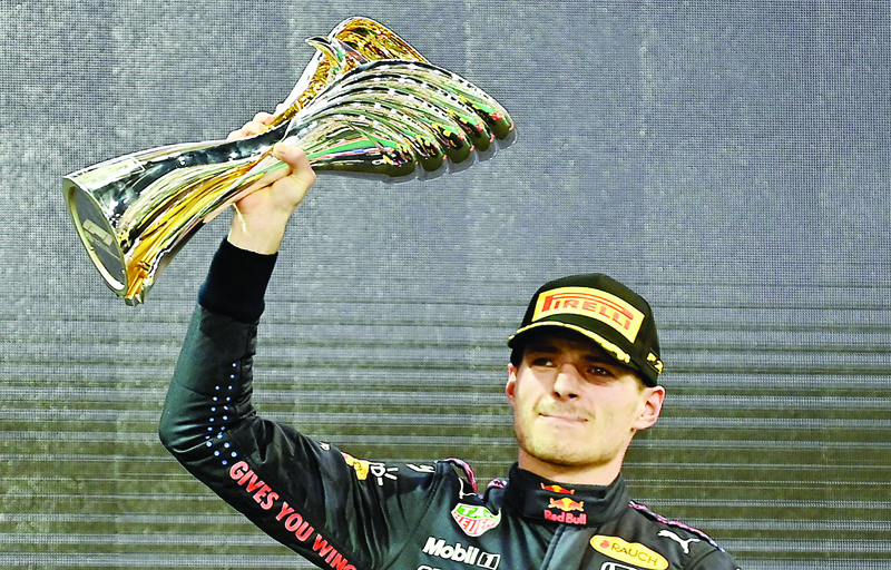 YAS ISLAND: 2021 FIA Formula One World Champion Red Bull's Dutch driver Max Verstappen celebrates on the podium of the Yas Marina Circuit after the Abu Dhabi Formula One Grand Prix yesterday. - AFP n