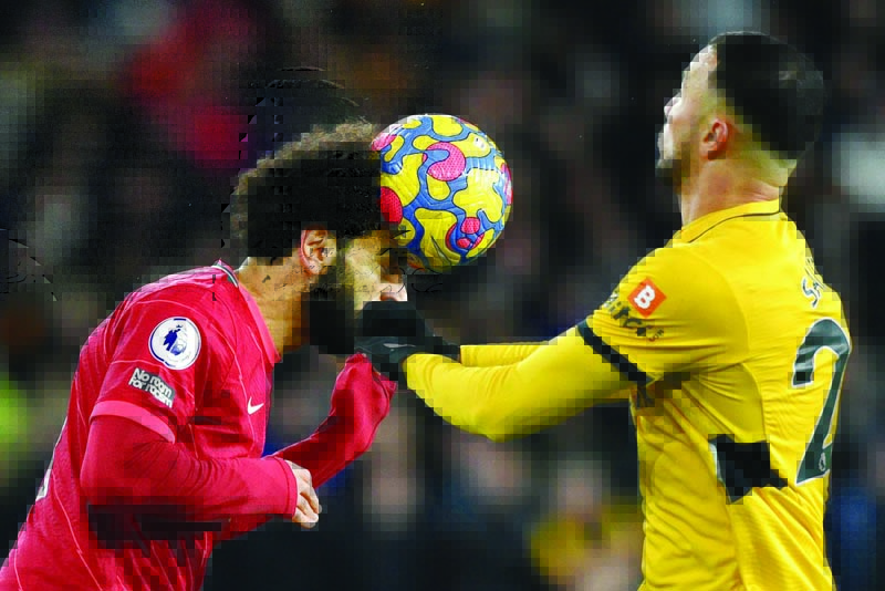 WOLVERHAMPTON: Liverpool's Egyptian midfielder Mohamed Salah (left) heads the ball during the English Premier League football match between Wolverhampton Wanderers and Liverpool at the Molineux stadium yesterday. - AFP n